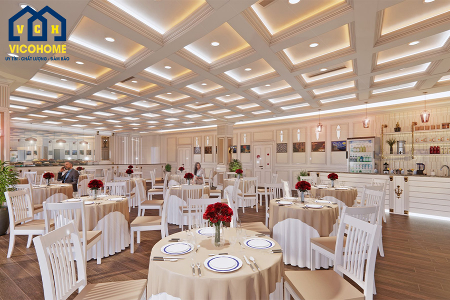 Không gian nhà hàng với màu be sơn tường chủ đạo kết hợp với bàn ghế trắng và điểm nhấn là những binh hoa màu sắc